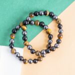 Triple Protection Bracelet Protection • Grounding • Confidence Experience the powerful synergy of Tiger's Eye, Black Tourmaline, and Hematite—three renowned crystals thoughtfully combined to support protection, grounding, and inner strength. Designed for everyday wear, this bracelet helps you stay centered, focused, and energetically balanced while navigating the demands of daily life. Crystal Benefits 🟤 Tiger's Eye Encourages confidence and courage Enhances focus and decision-making Promotes motivation and personal strength ⚫ Black Tourmaline Helps shield against negative energies Supports emotional balance and stability Encourages a sense of security and protection ⚙️ Hematite Grounds and stabilizes your energy Improves mental clarity and concentration Promotes balance, resilience, and calmness Why You'll Love It Crafted with genuine Tiger's Eye, Black Tourmaline, and Hematite beads Ideal for daily wear, meditation, travel, and work A meaningful gift for anyone seeking protection, confidence, and emotional balance Suitable for both men and women Care Instructions To maintain your bracelet's beauty and energetic integrity, avoid prolonged exposure to water, perfumes, and harsh chemicals. Cleanse and recharge your crystals regularly using your preferred spiritual practice. Disclaimer: Crystal healing is a complementary spiritual practice and is not intended to diagnose, treat, cure, or prevent any medical condition. The bracelet is designed to support your wellness journey alongside a healthy lifestyle.
