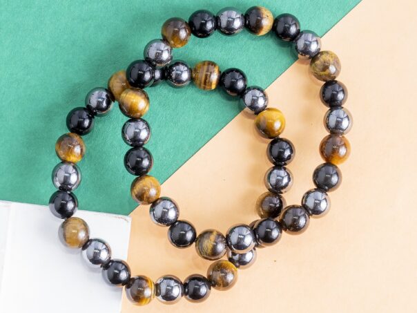 Triple Protection Bracelet Protection • Grounding • Confidence Experience the powerful synergy of Tiger's Eye, Black Tourmaline, and Hematite—three renowned crystals thoughtfully combined to support protection, grounding, and inner strength. Designed for everyday wear, this bracelet helps you stay centered, focused, and energetically balanced while navigating the demands of daily life. Crystal Benefits 🟤 Tiger's Eye Encourages confidence and courage Enhances focus and decision-making Promotes motivation and personal strength ⚫ Black Tourmaline Helps shield against negative energies Supports emotional balance and stability Encourages a sense of security and protection ⚙️ Hematite Grounds and stabilizes your energy Improves mental clarity and concentration Promotes balance, resilience, and calmness Why You'll Love It Crafted with genuine Tiger's Eye, Black Tourmaline, and Hematite beads Ideal for daily wear, meditation, travel, and work A meaningful gift for anyone seeking protection, confidence, and emotional balance Suitable for both men and women Care Instructions To maintain your bracelet's beauty and energetic integrity, avoid prolonged exposure to water, perfumes, and harsh chemicals. Cleanse and recharge your crystals regularly using your preferred spiritual practice. Disclaimer: Crystal healing is a complementary spiritual practice and is not intended to diagnose, treat, cure, or prevent any medical condition. The bracelet is designed to support your wellness journey alongside a healthy lifestyle.