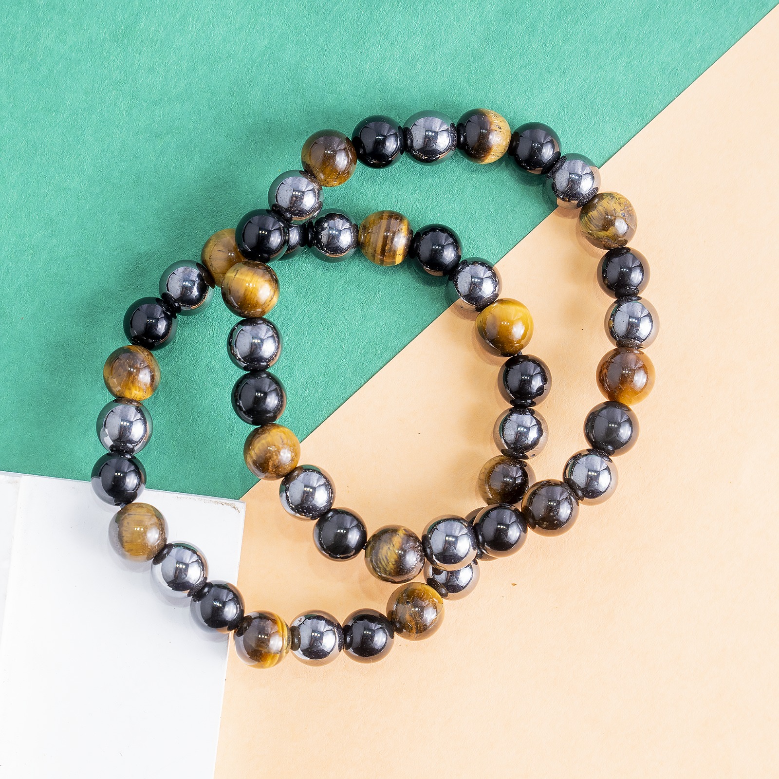 Triple Protection Bracelet Protection • Grounding • Confidence Experience the powerful synergy of Tiger's Eye, Black Tourmaline, and Hematite—three renowned crystals thoughtfully combined to support protection, grounding, and inner strength. Designed for everyday wear, this bracelet helps you stay centered, focused, and energetically balanced while navigating the demands of daily life. Crystal Benefits 🟤 Tiger's Eye Encourages confidence and courage Enhances focus and decision-making Promotes motivation and personal strength ⚫ Black Tourmaline Helps shield against negative energies Supports emotional balance and stability Encourages a sense of security and protection ⚙️ Hematite Grounds and stabilizes your energy Improves mental clarity and concentration Promotes balance, resilience, and calmness Why You'll Love It Crafted with genuine Tiger's Eye, Black Tourmaline, and Hematite beads Ideal for daily wear, meditation, travel, and work A meaningful gift for anyone seeking protection, confidence, and emotional balance Suitable for both men and women Care Instructions To maintain your bracelet's beauty and energetic integrity, avoid prolonged exposure to water, perfumes, and harsh chemicals. Cleanse and recharge your crystals regularly using your preferred spiritual practice. Disclaimer: Crystal healing is a complementary spiritual practice and is not intended to diagnose, treat, cure, or prevent any medical condition. The bracelet is designed to support your wellness journey alongside a healthy lifestyle.